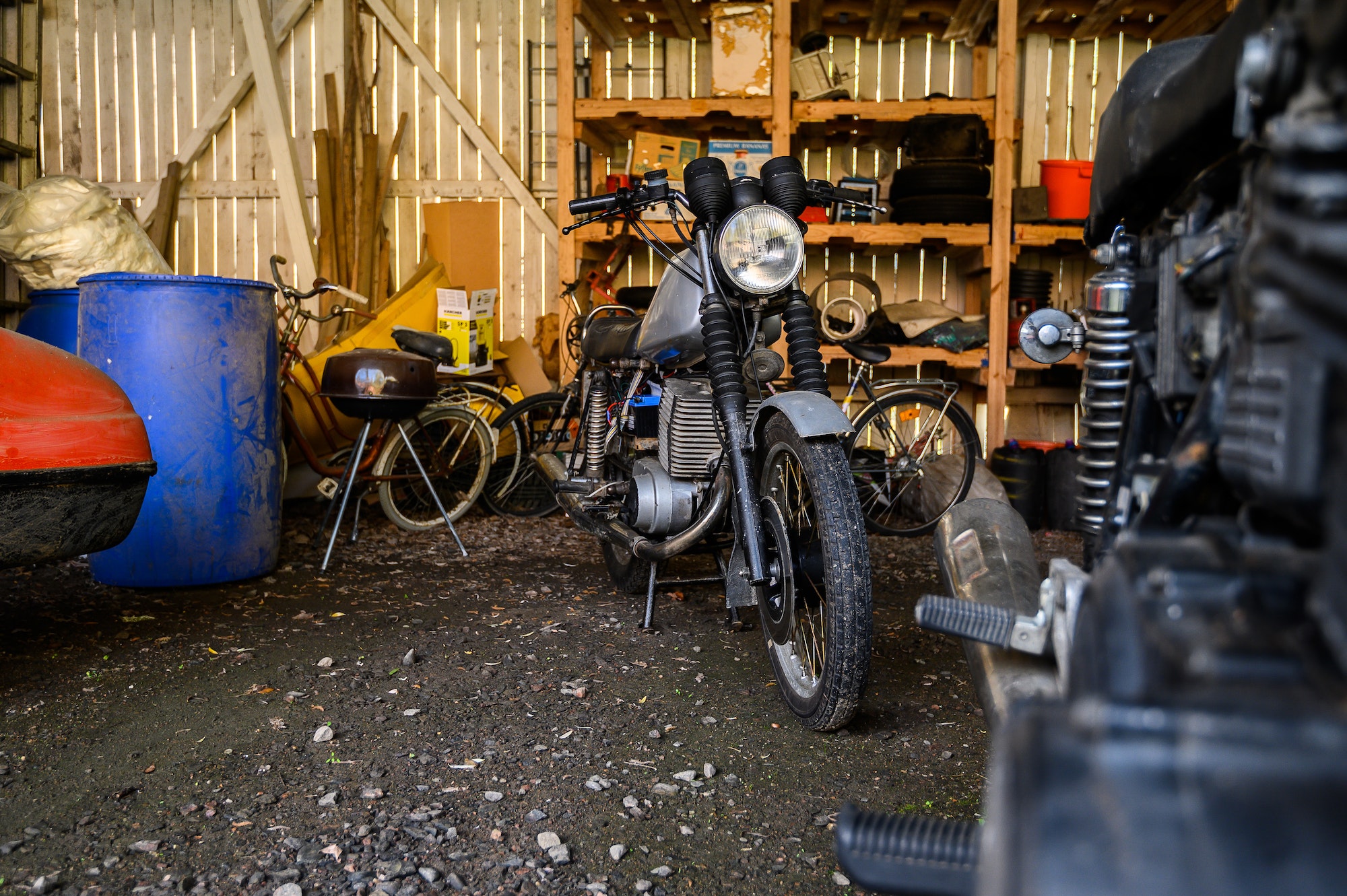 10.10.2019 Helsinki, Finland - open garage space, with vintage motorcycle in storage on shelving.