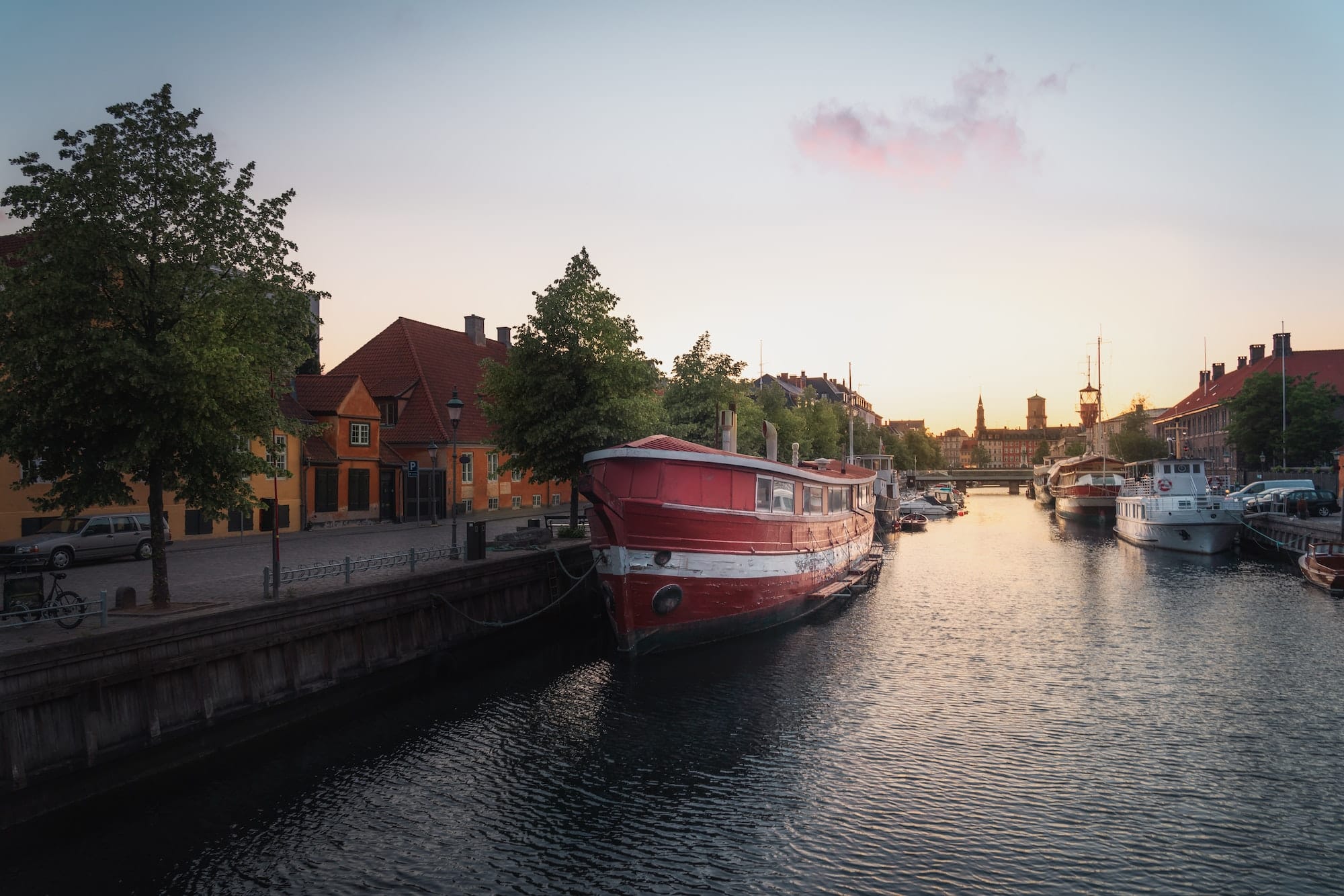 Christians Brygge canal and boats at sunset - Copenhagen, Denmark