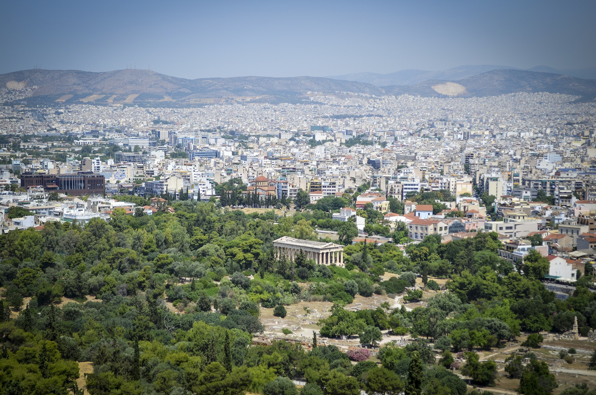 Cityscape of Athens, Greece, with the Parthenon in the foreground.