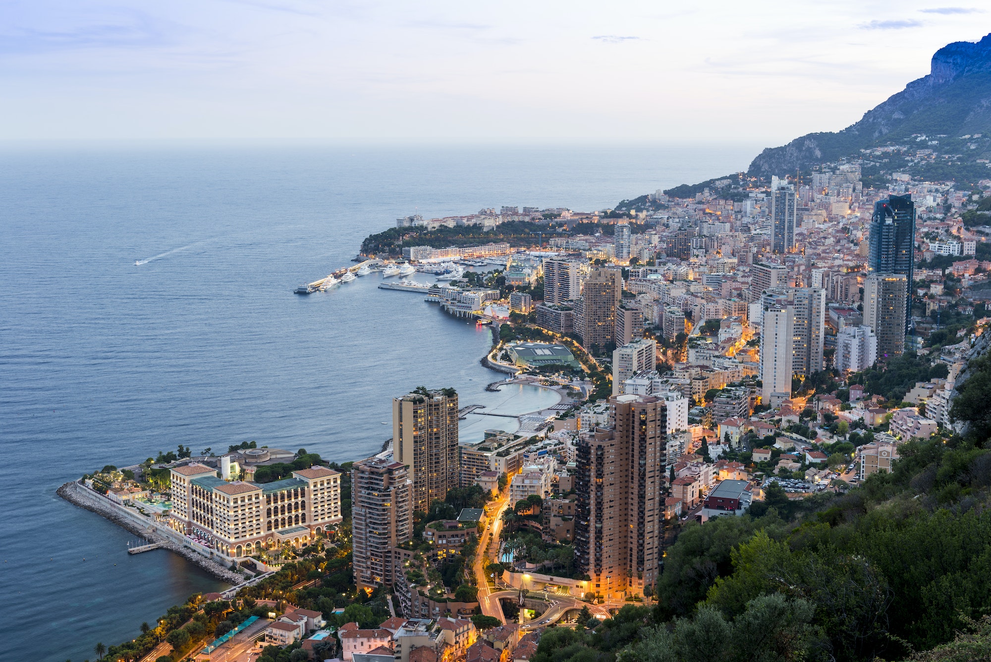 Coastal cityscape with skyscrapers and hotels at dusk, Monaco