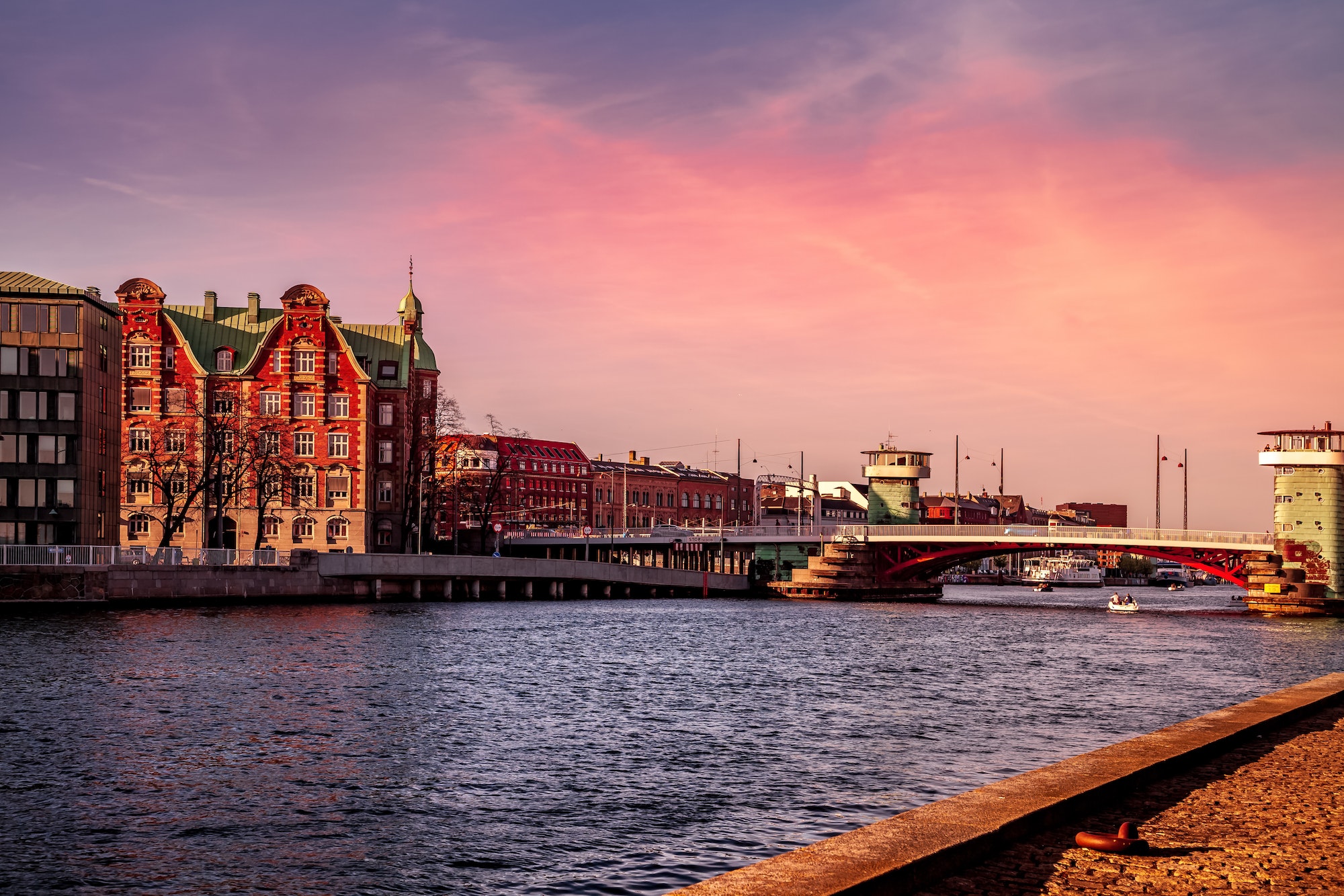 COPENHAGEN, DENMARK - MAY 6, 2018: scenic view of cityscape with river and bridge in foreground