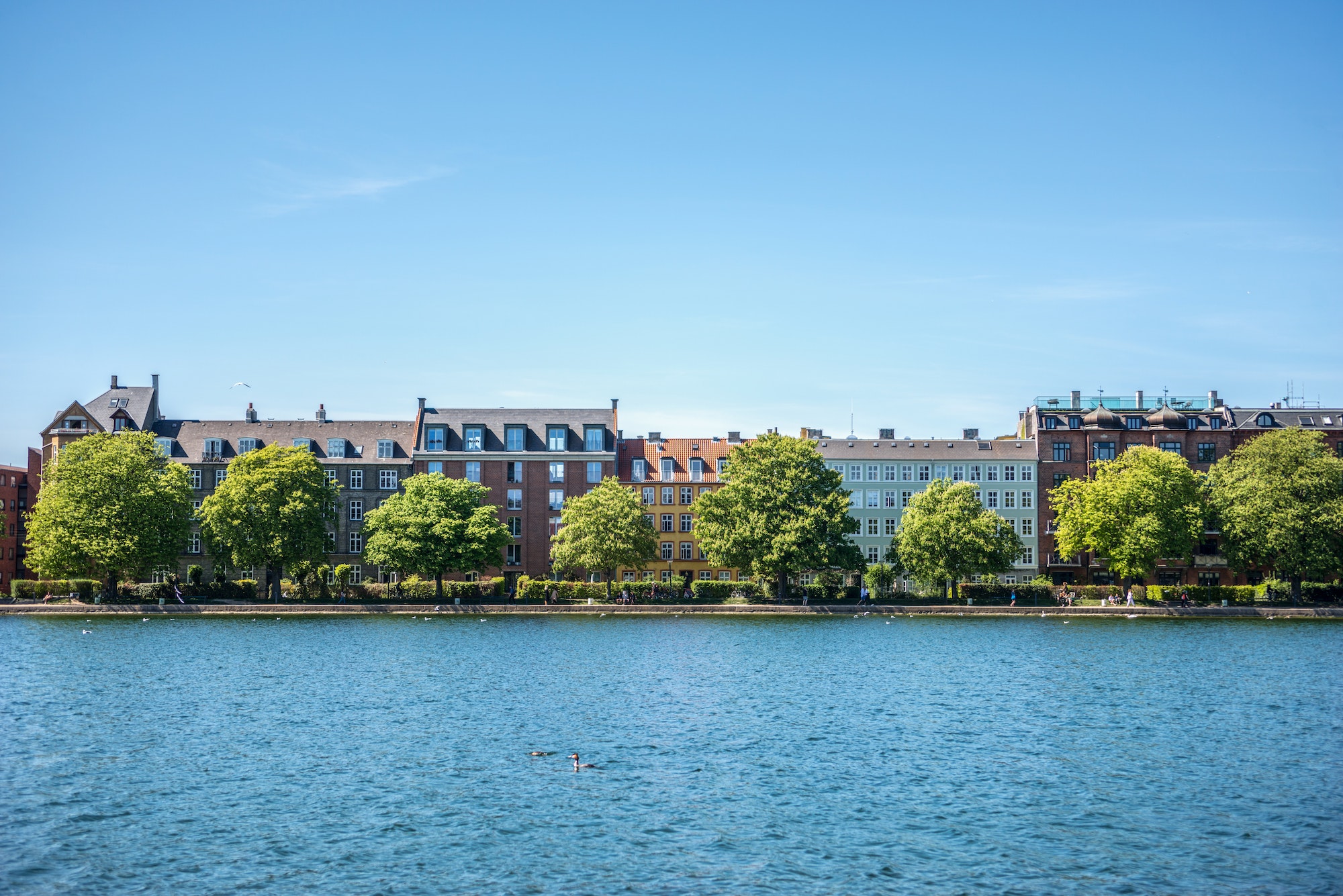 COPENHAGEN, DENMARK - MAY 6, 2018: urban scene with city river, buildings and clear blue sky in