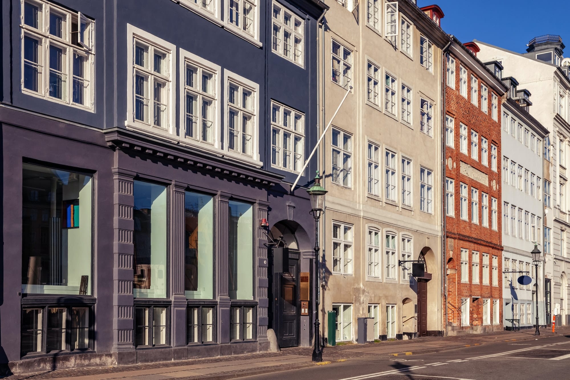empty street with beautiful colorful buildings in copenhagen, denmark