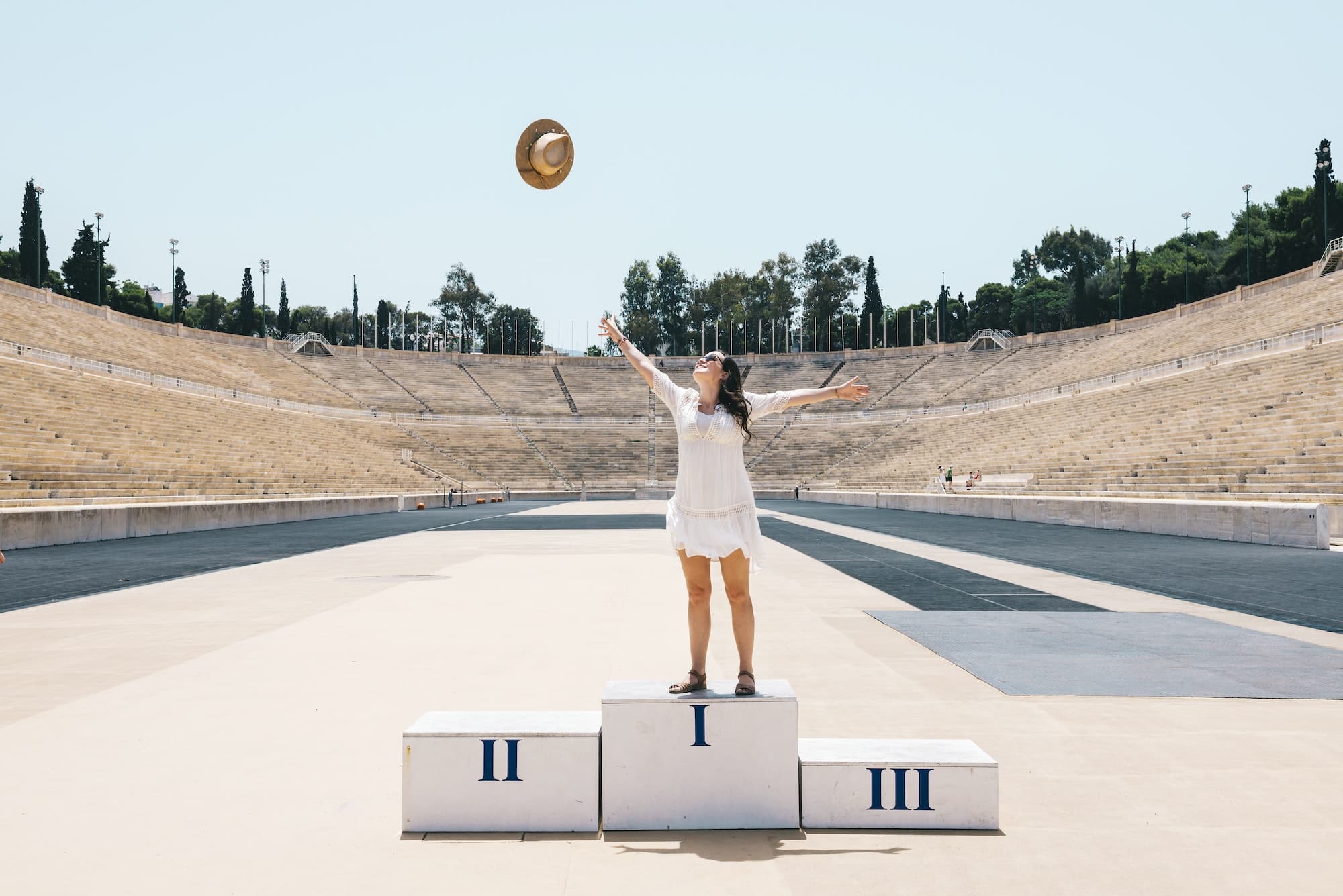 Greece, Athens, woman on the podium celebrating in the Panathenaic Stadium