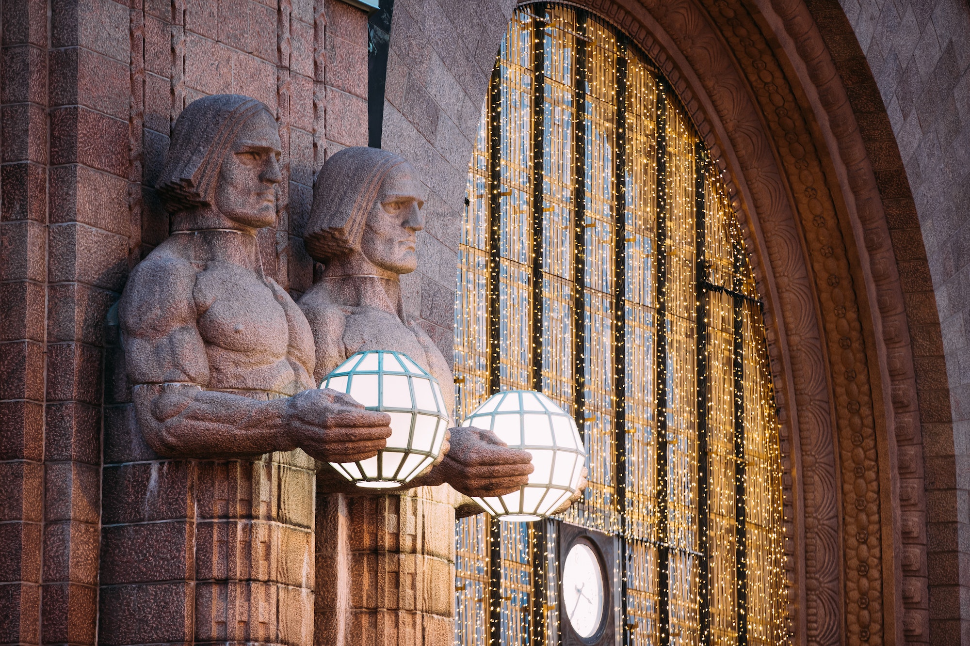 Helsinki, Finland. Night View Of Two Pairs Of Statues Holding Th