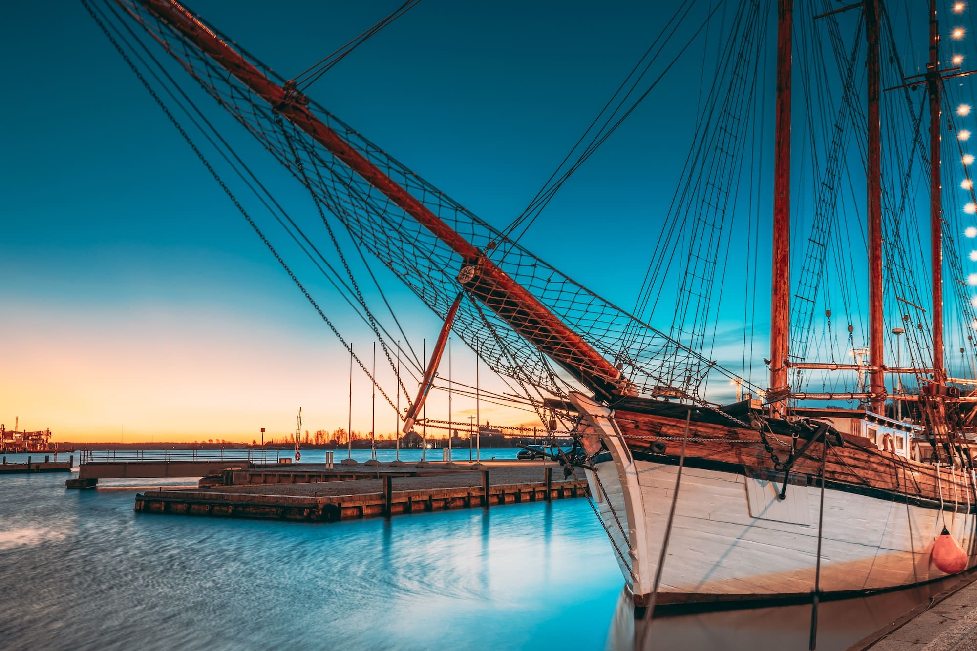 Helsinki, Finland. Old Wooden Sailing Vessel Ship Schooner Is Moored To City Pier, Jetty. Lighting