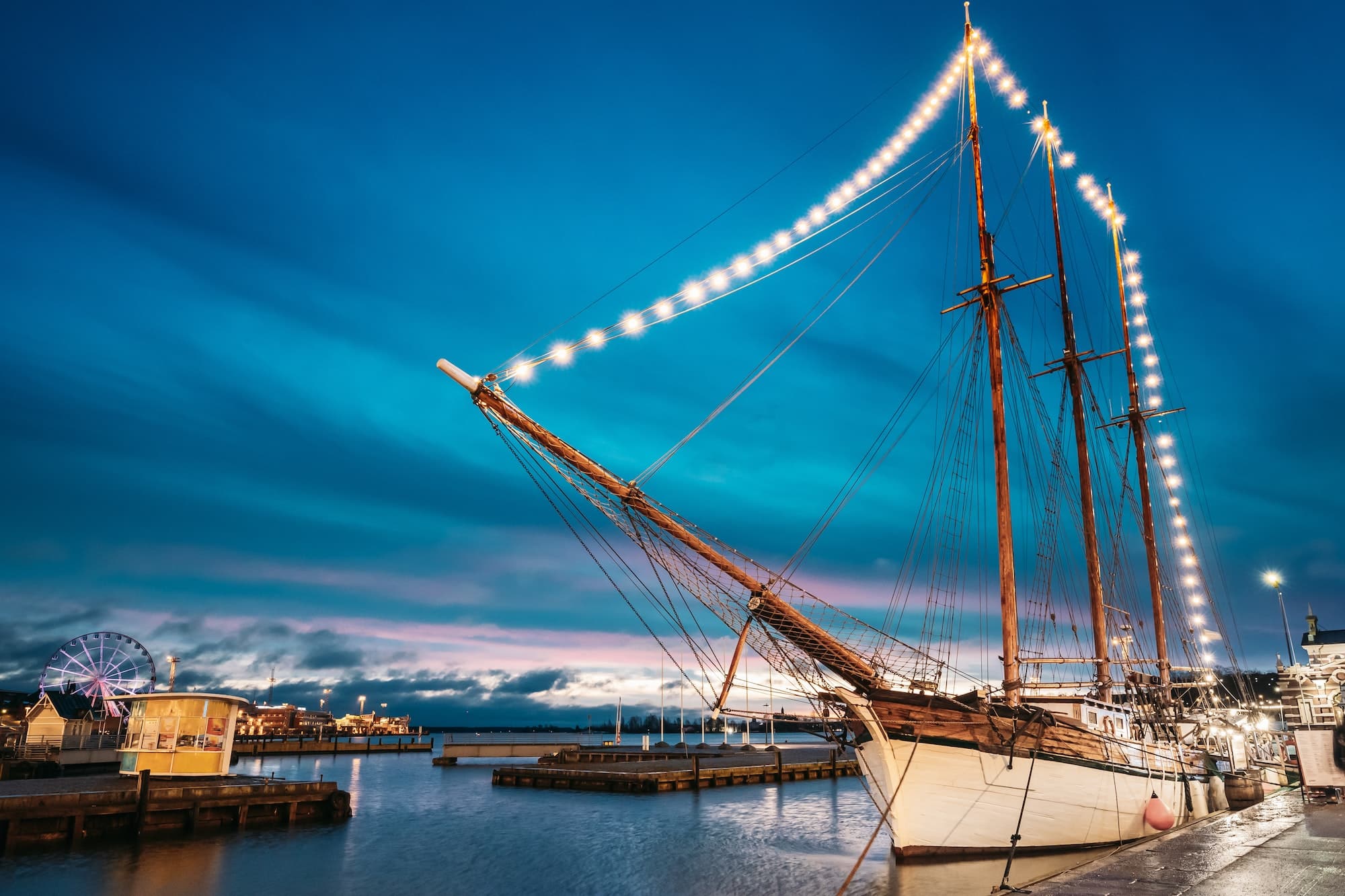 Helsinki, Finland. Old Wooden Sailing Vessel Ship Schooner Is Moored To The City Pier, Jetty