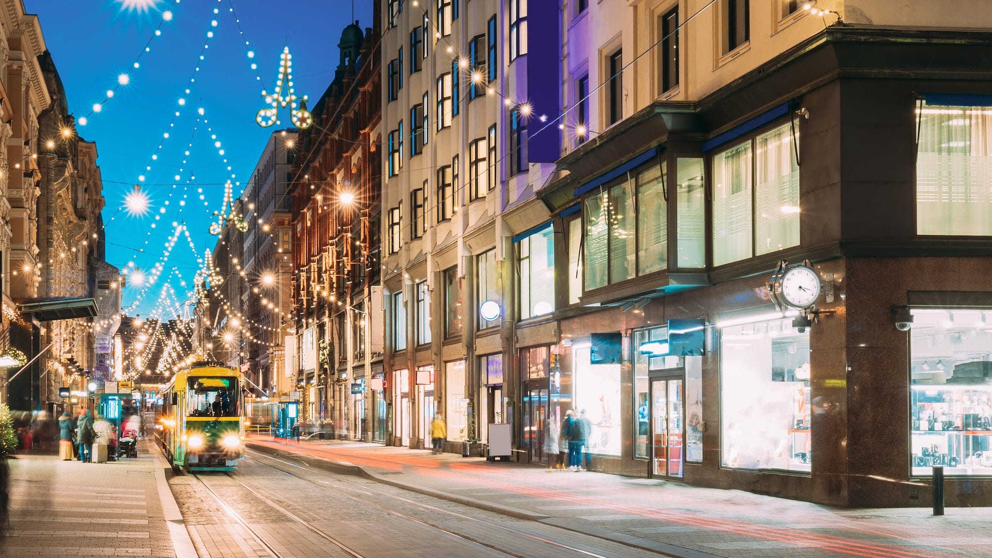 Helsinki, Finland. Tram Departs From Stop On Aleksanterinkatu Street. Kluuvi District In Evening Or