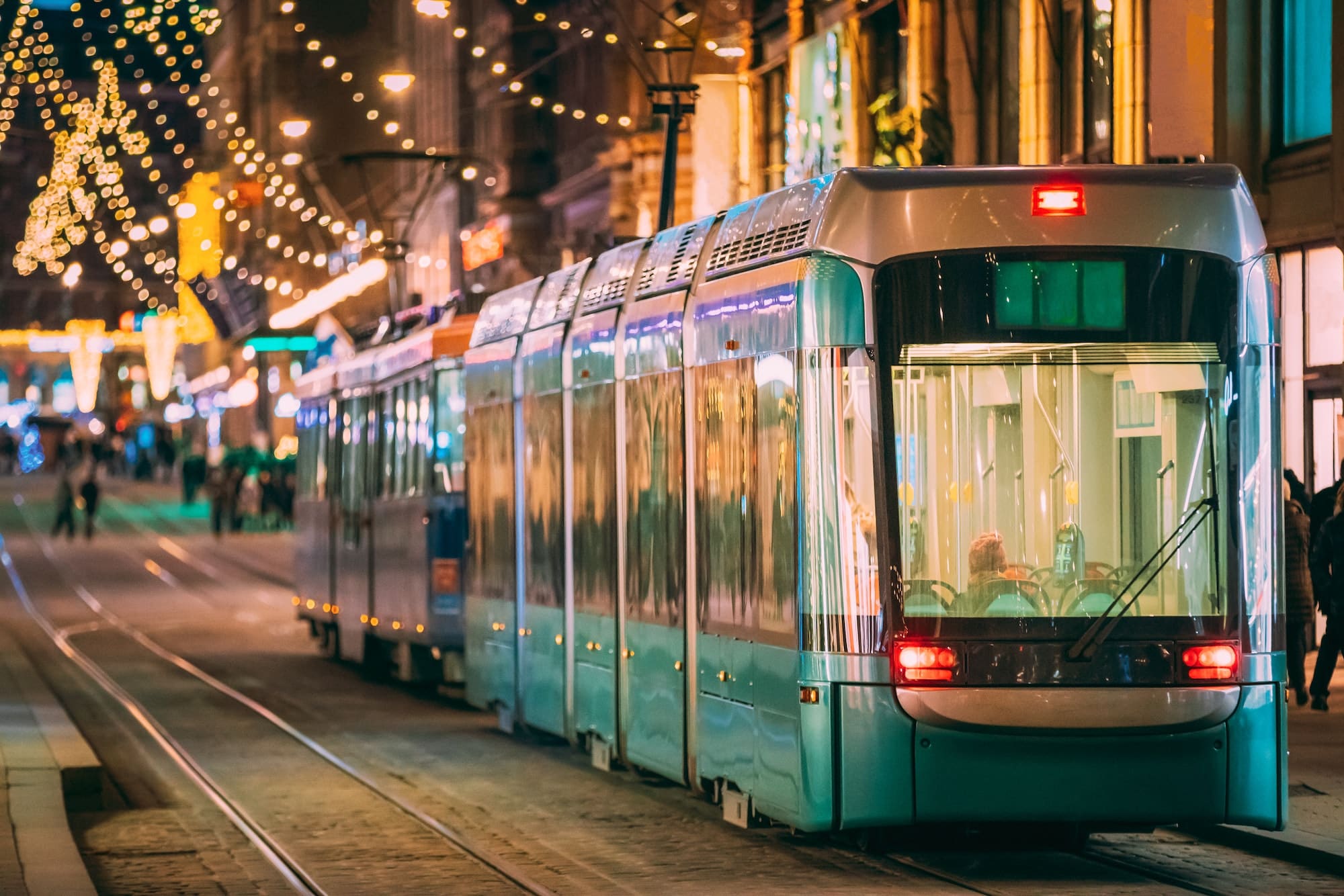 Helsinki, Finland. Tram Departs From Stop On Aleksanterinkatu Street. Night Evening Christmas Xmas