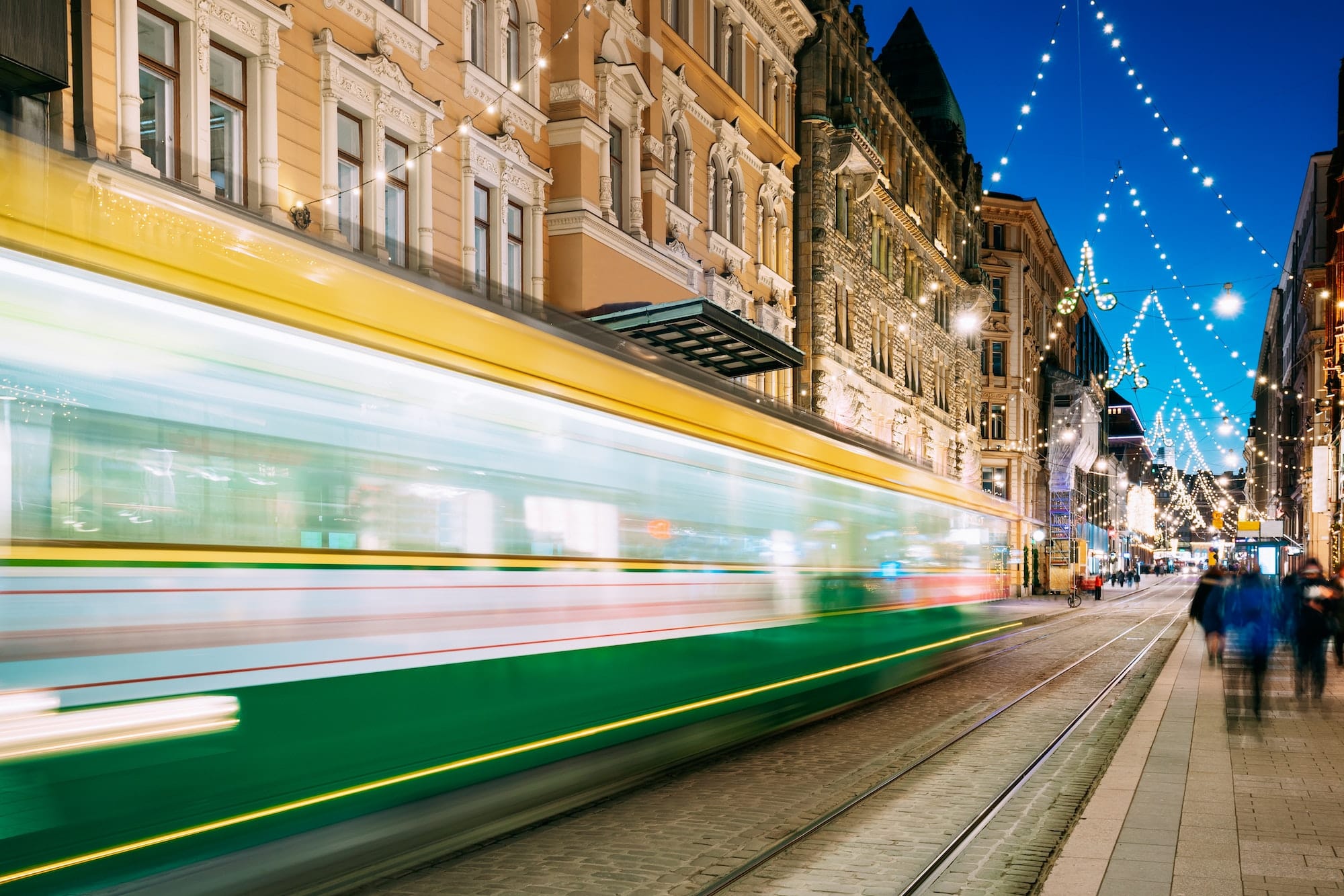 Helsinki, Finland. Tram Departs In Motion Blur From Stop On Aleksanterinkatu Street In Kluuvi