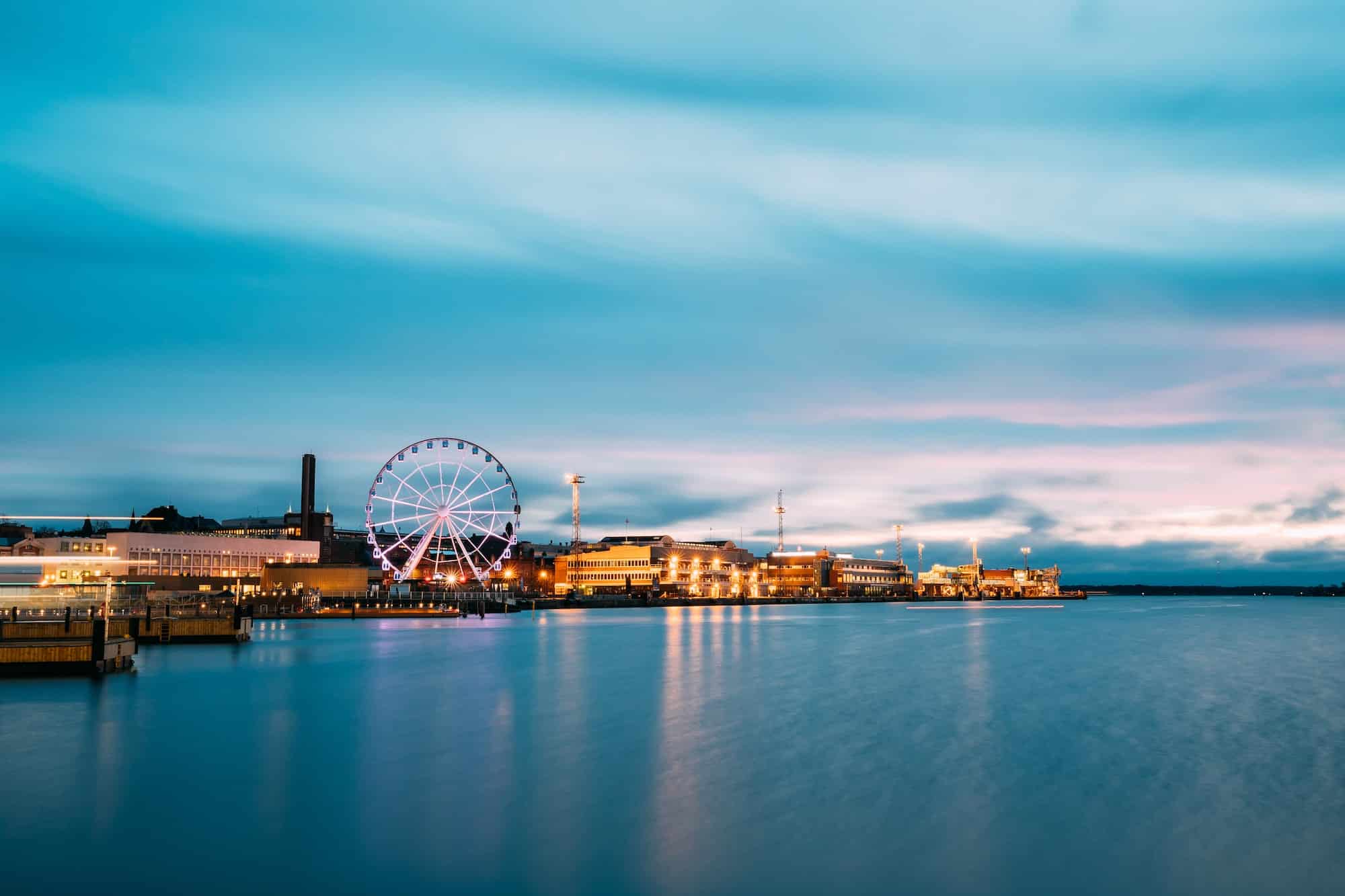 Helsinki, Finland. View Of Embankment With Ferris Wheel In Eveni