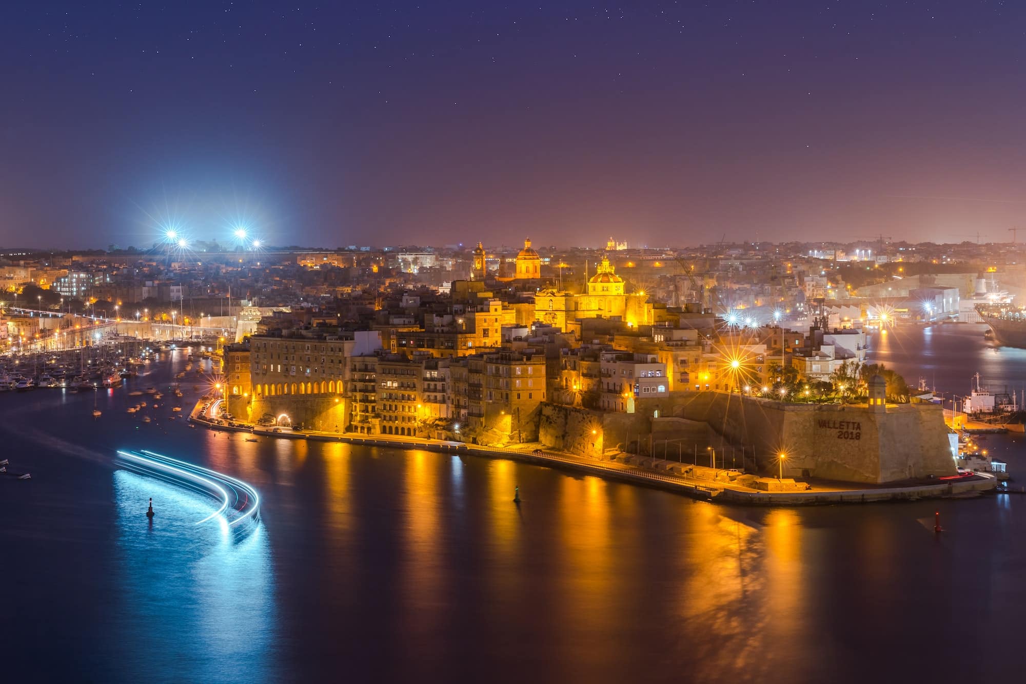 Illuminated skyline of Senglea and Three Cities from Grand Harbo