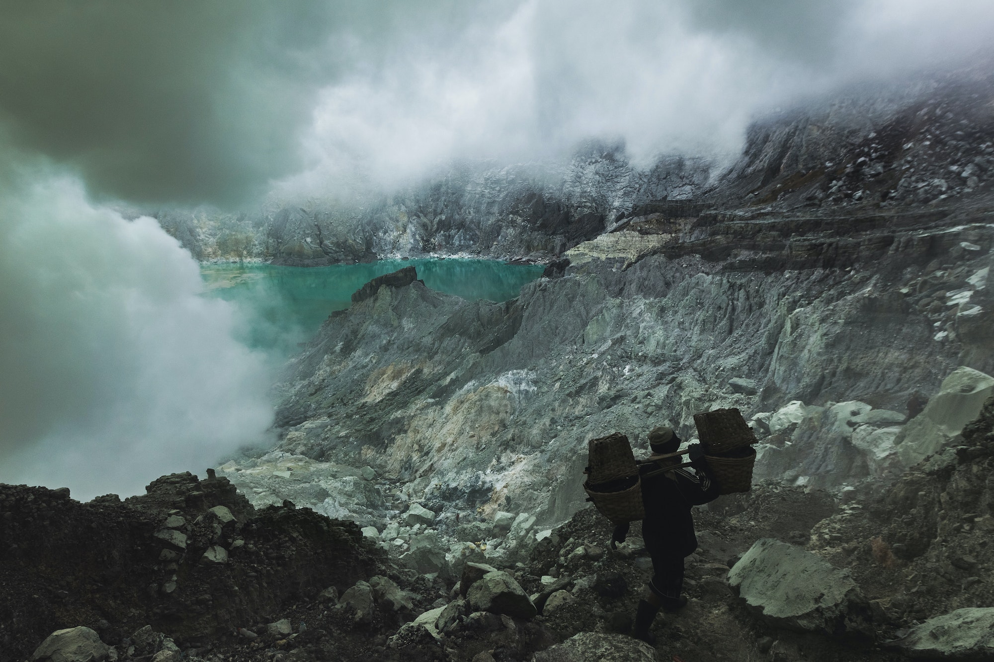 JAVA, INDONESIA - JANUARY 21, 2016: Extracting sulphur inside Kawah Ijen crater, Indonesia