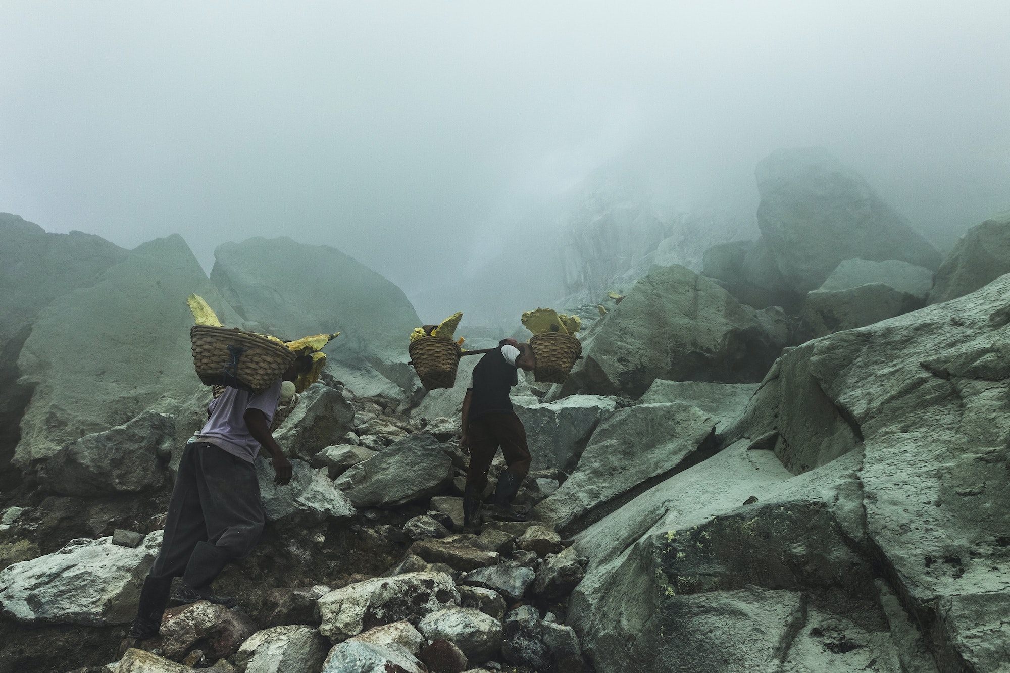 JAVA, INDONESIA - JANUARY 21, 2016: Extracting sulphur inside Kawah Ijen crater, Indonesia