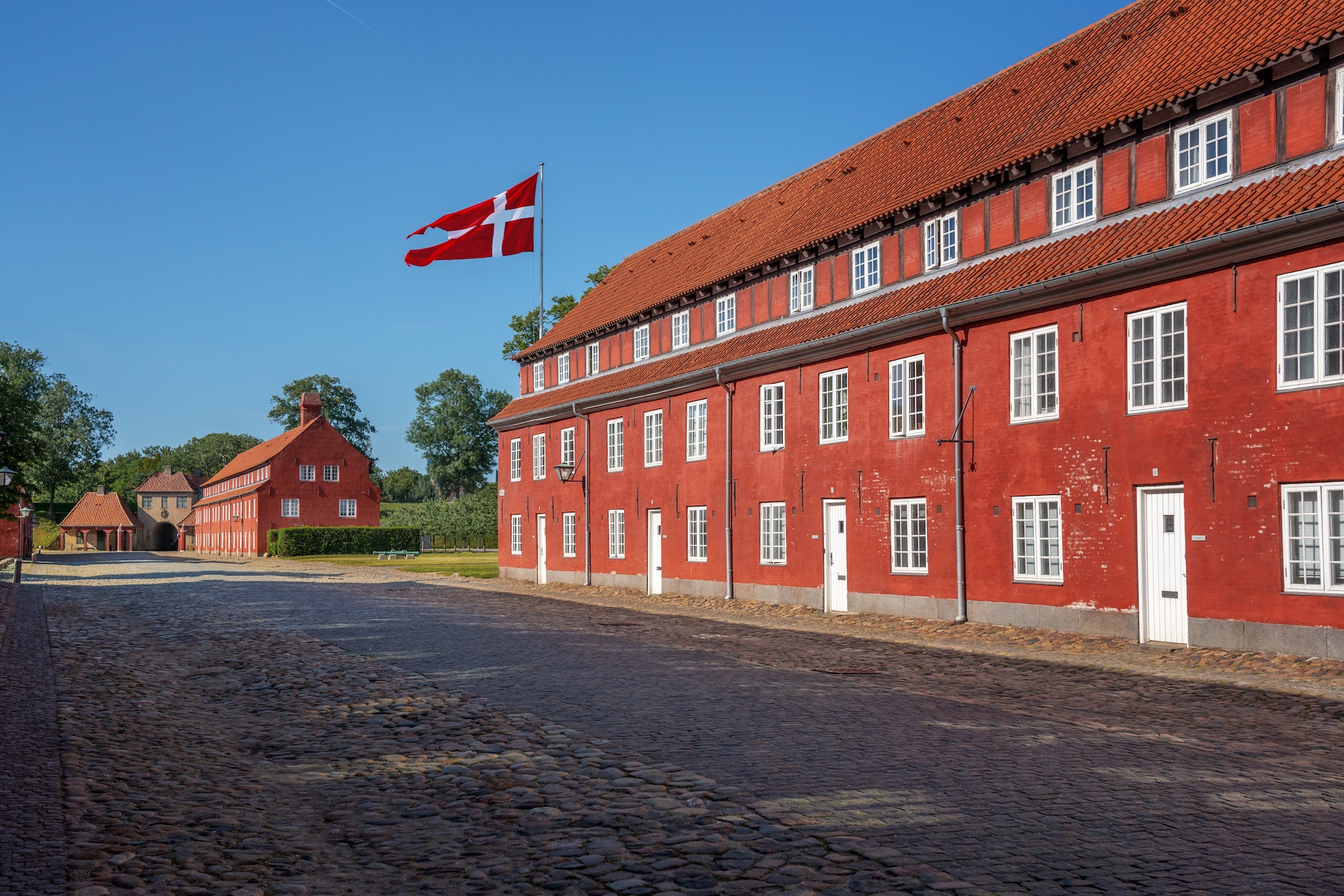 Kastellet fortress buildings (The Citadel) with the flag of Denmark - Copenhagen, Denmark