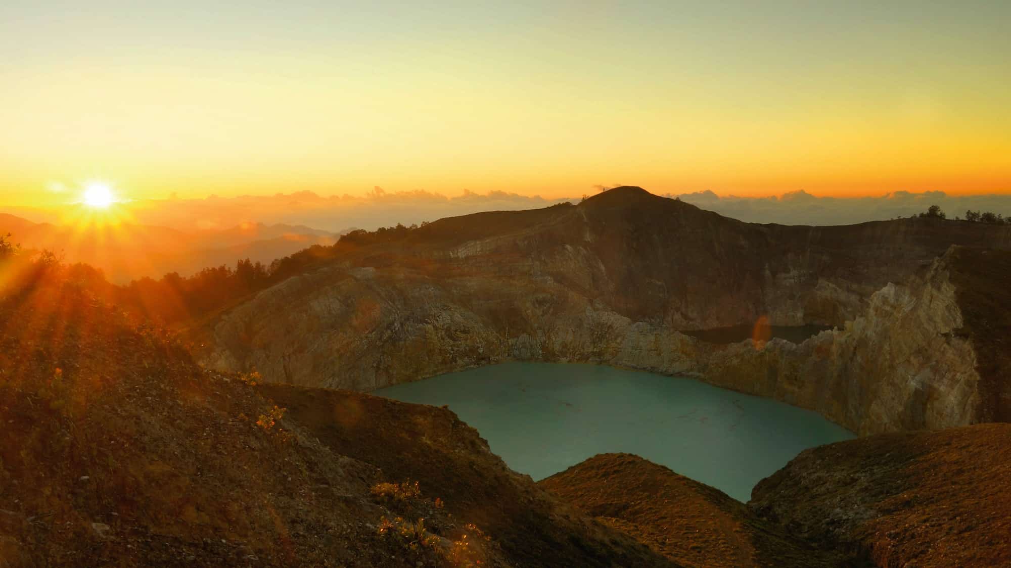 Lake in the Kelimutu volcano in Indonesia in the morning at sunrise.