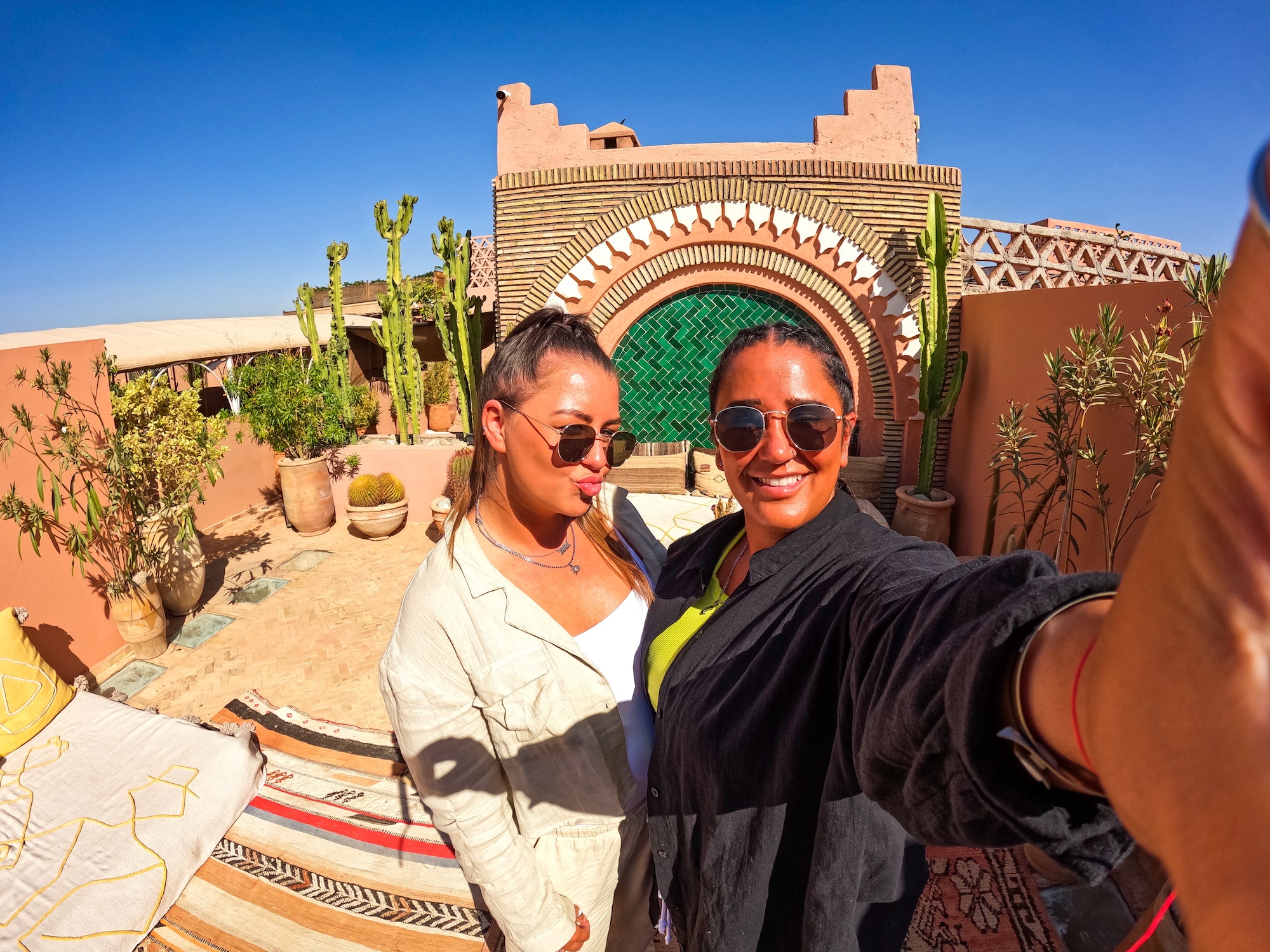 LGBTQ cute lesbian gay selfie in hotel riad in Marrakech Morocco, girl with braids, summer