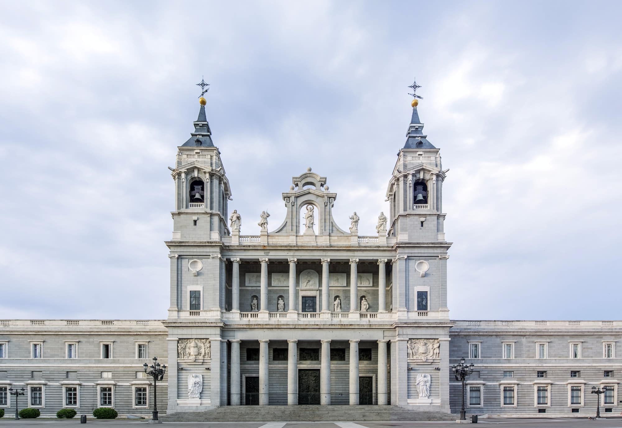 Ornate cathedral and cloudy sky, Madrid, Madrid, Spain