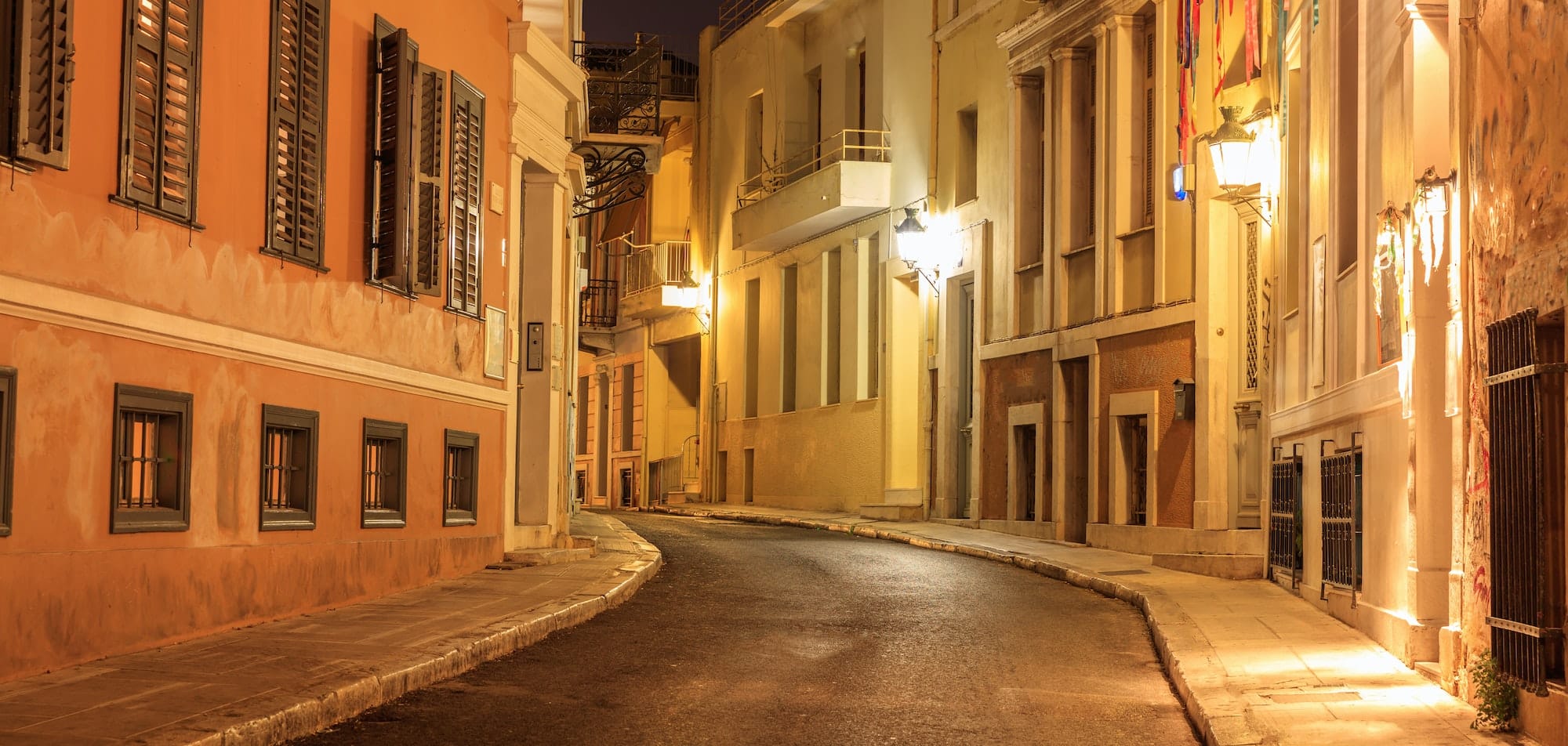 Plaka by night, Athens, traditional buildings at the sides of a street. Architecture in Greece.