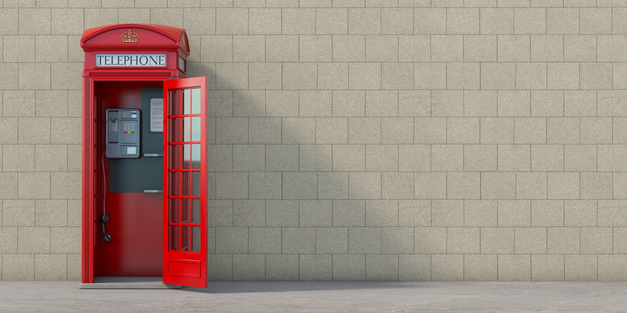 Red phone booth with hanging receiver on wall background. London