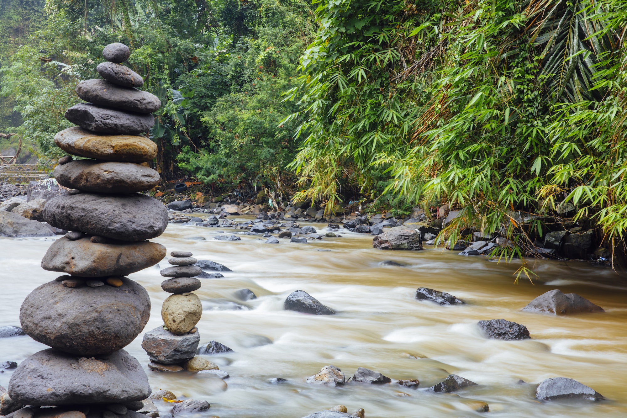 Stacked zen stones at Tegenungan Waterfall at Bali, Indonesia