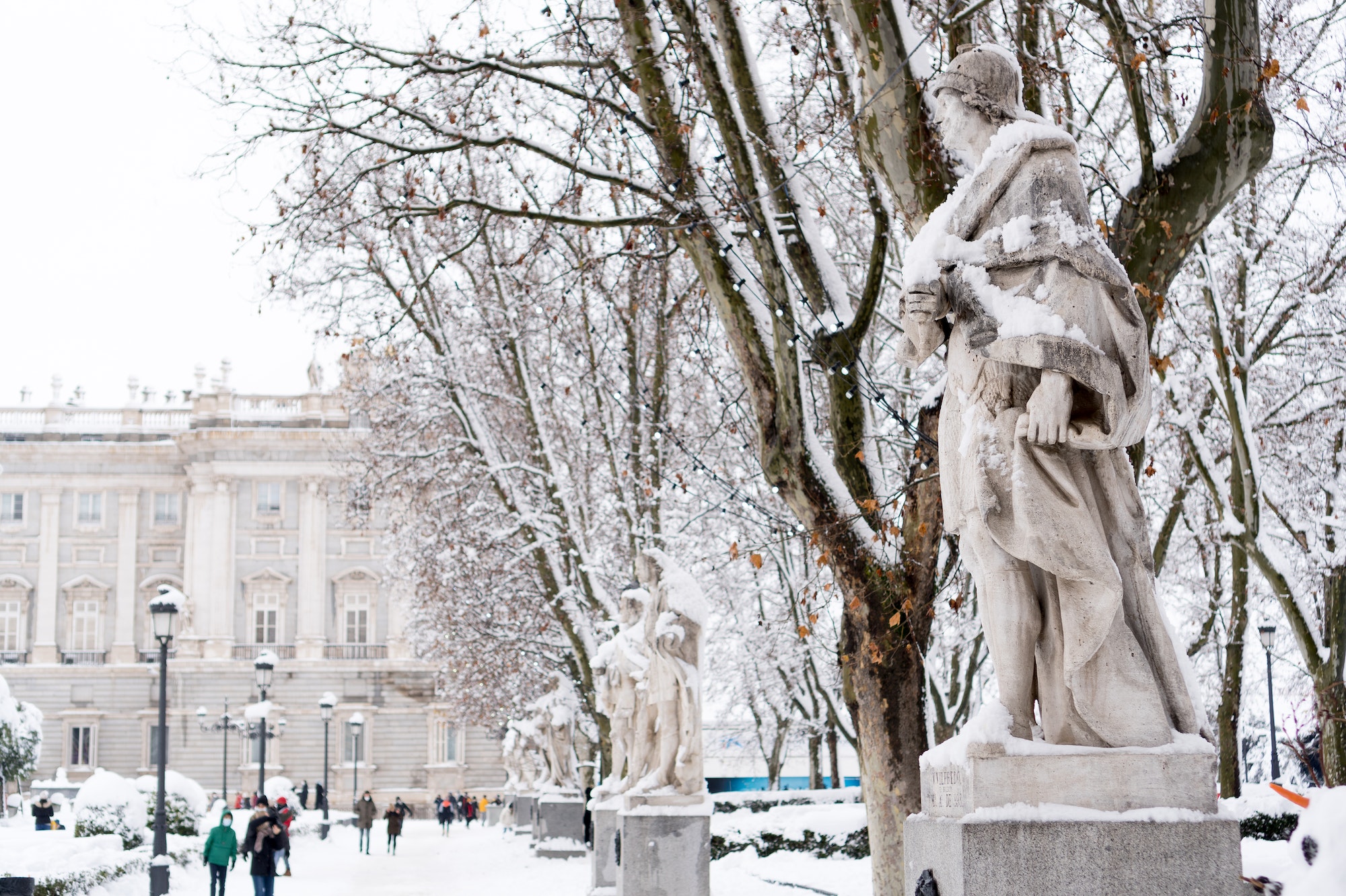Statues covered by snow in the Plaza de Oriente in Madrid (selective focus).