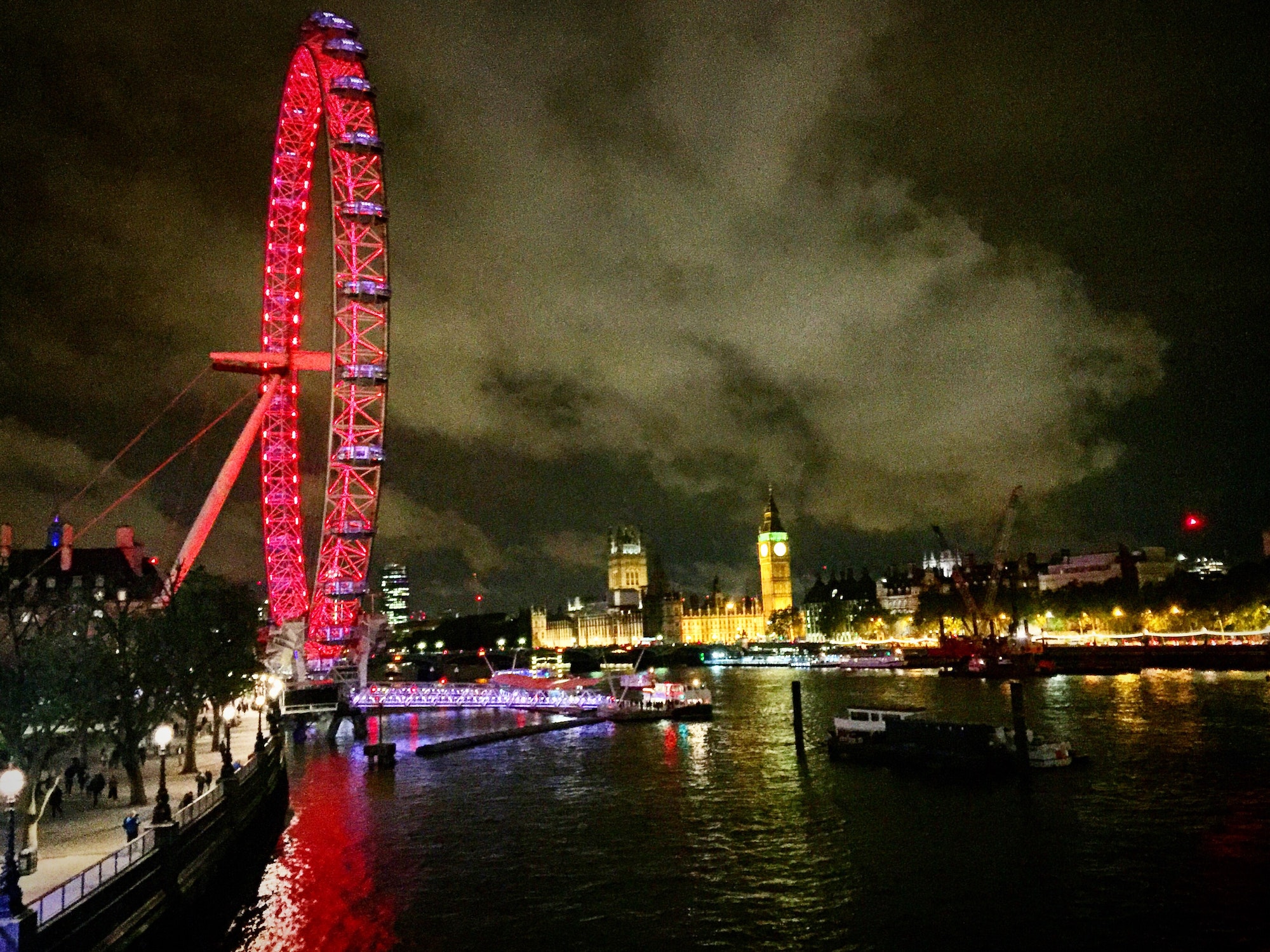 The London eye lit up in red at night