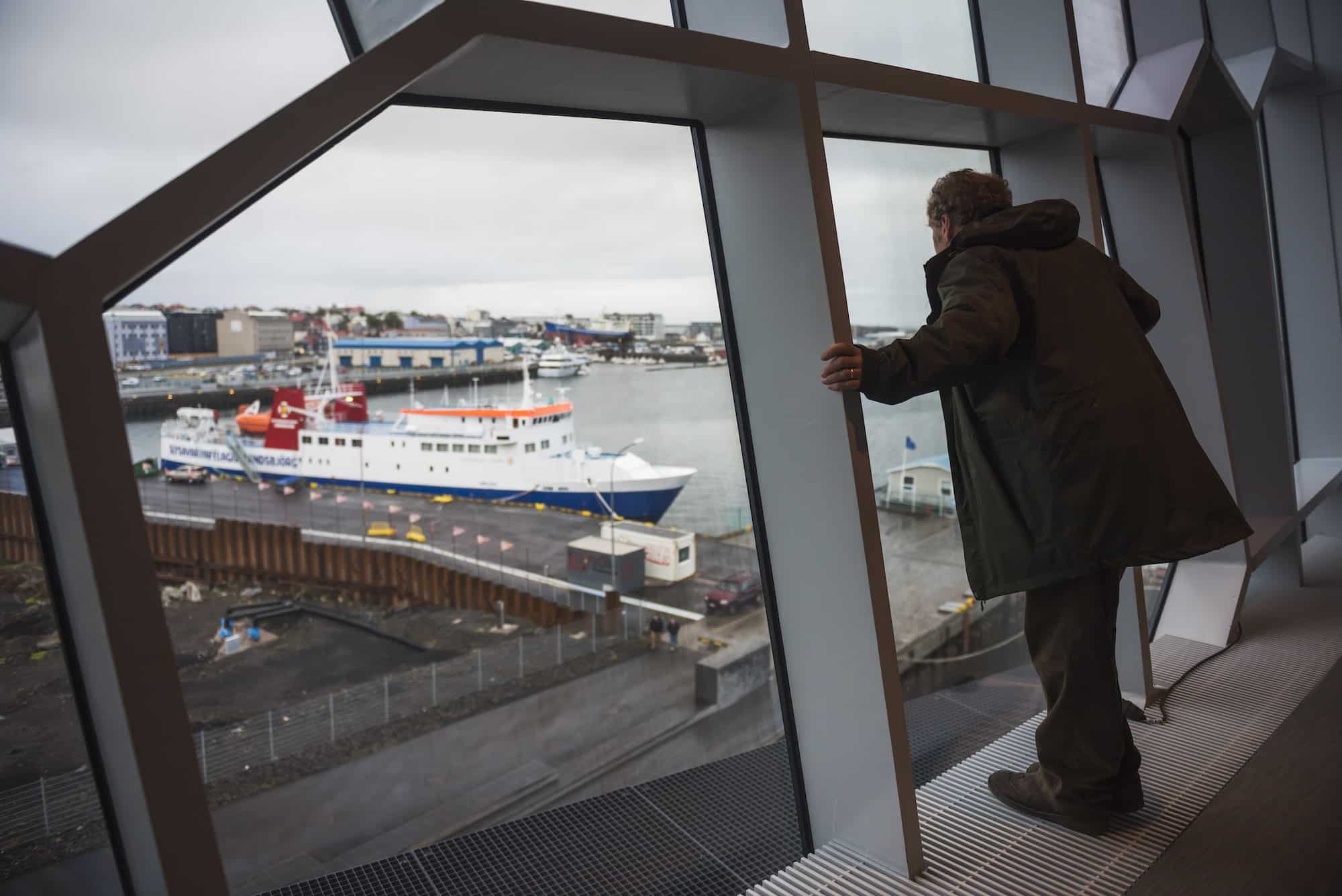 Tourist at Harpa Concert Hall and Conference Centre, Reykjavik, Iceland