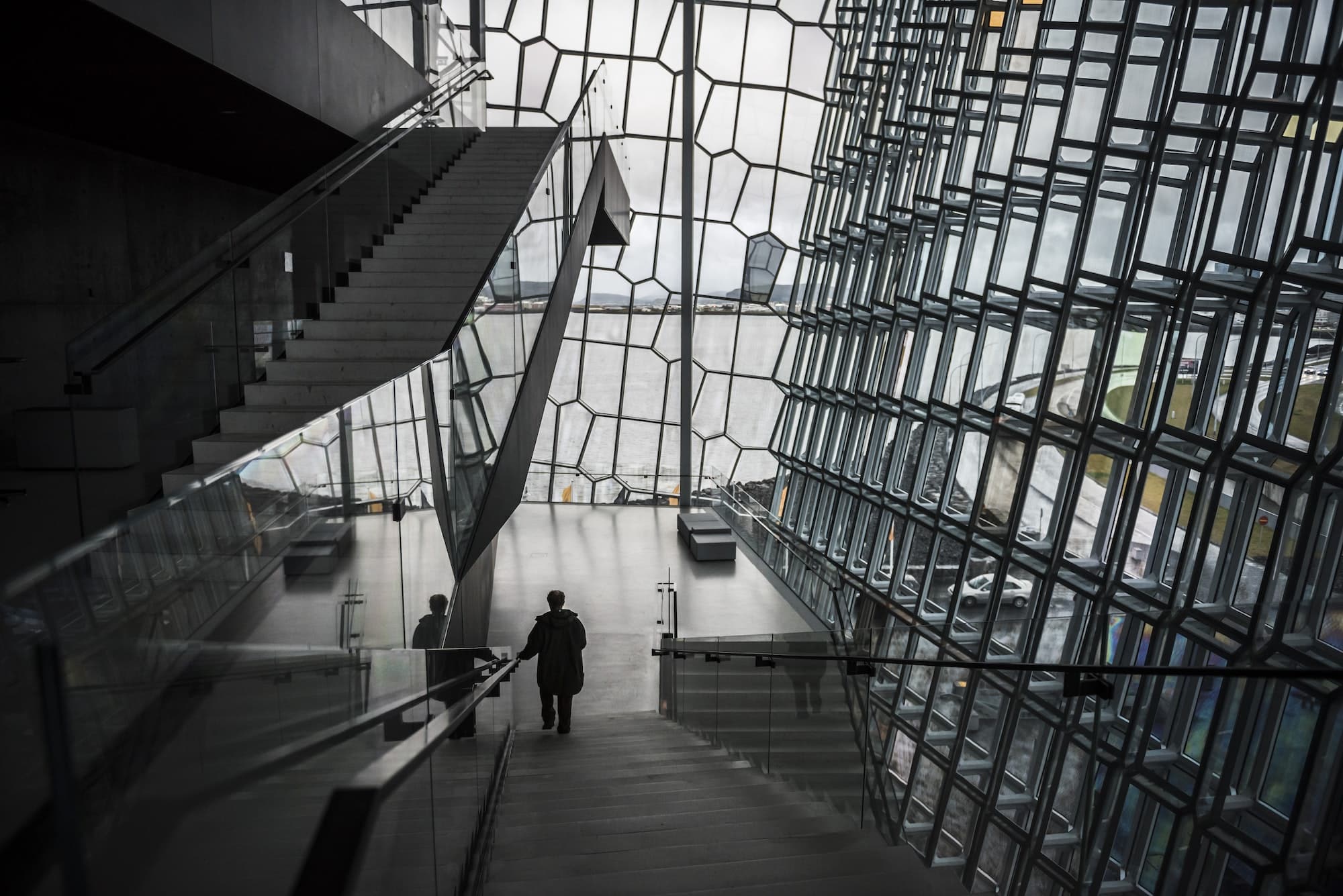 Tourist man sightseeing at Harpa Concert Hall and Conference Centre, Reykjavik, Iceland, Europe