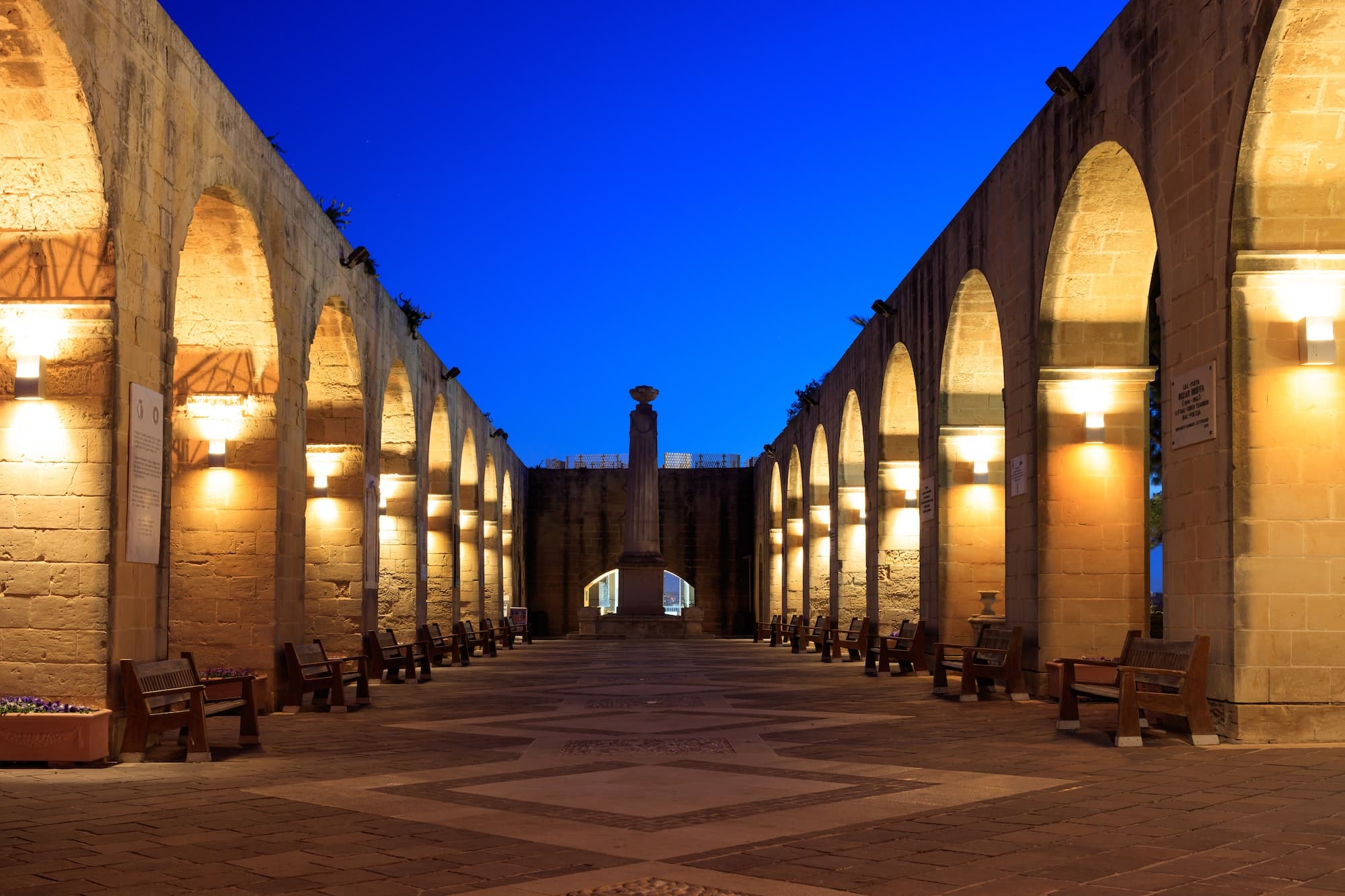 Valletta, Malta, Upper Barrakka Gardens. Illuminated stone arches in the evening