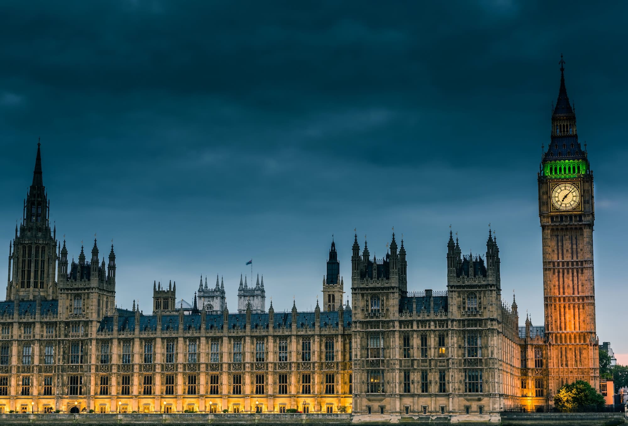 Westminster abbey and big ben in the London skyline at night, London, UK