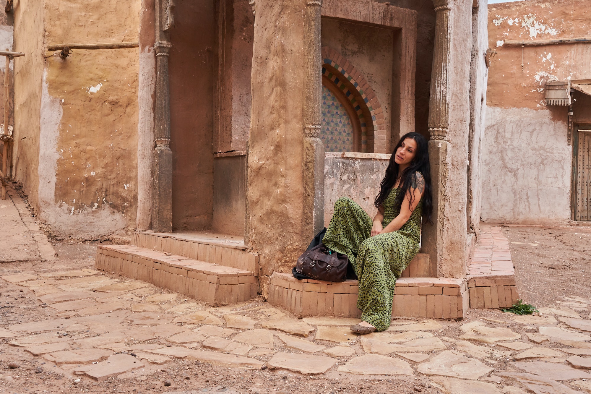 Woman on street between ancient buildings