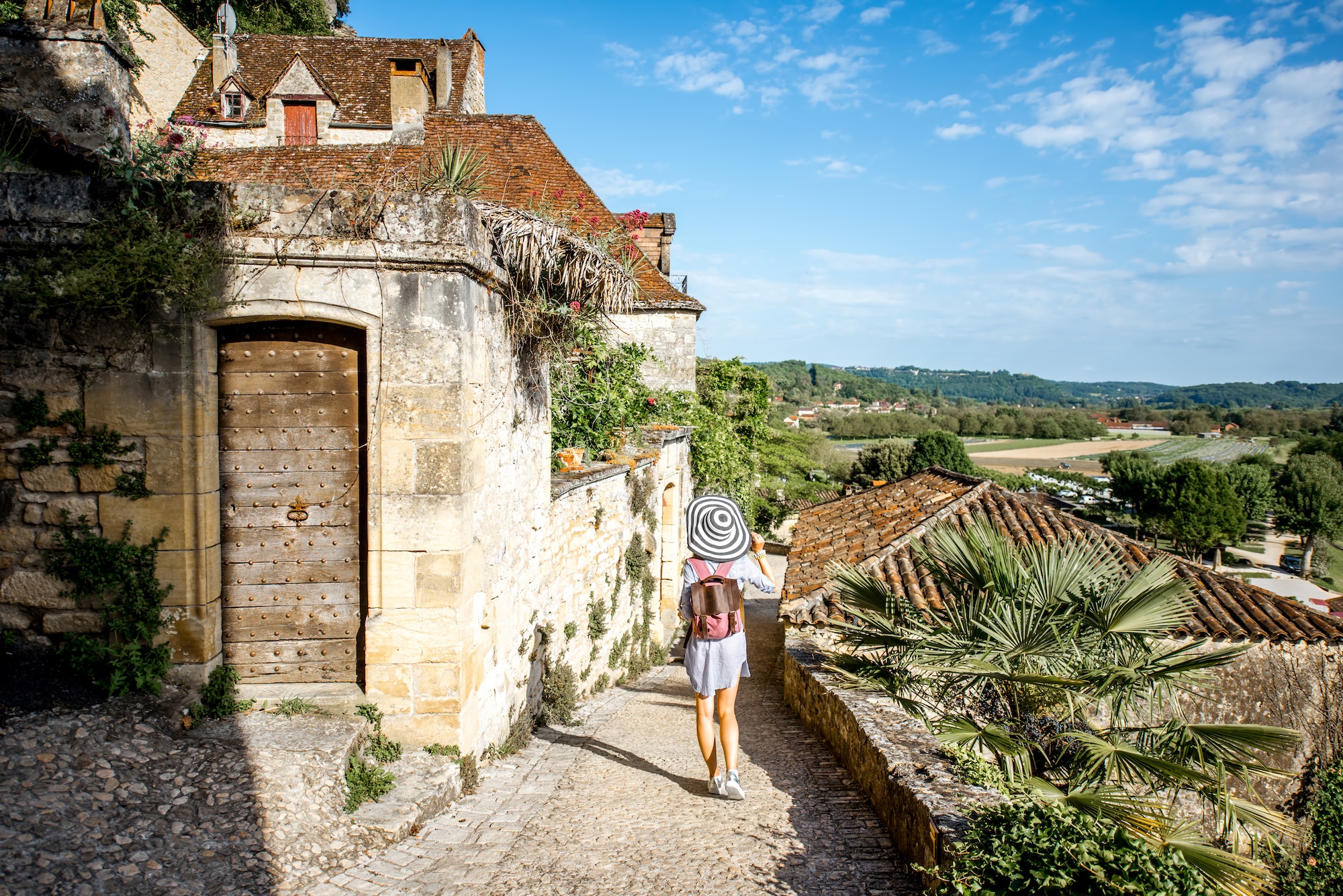 Woman traveling in La Roque Gageac village, France