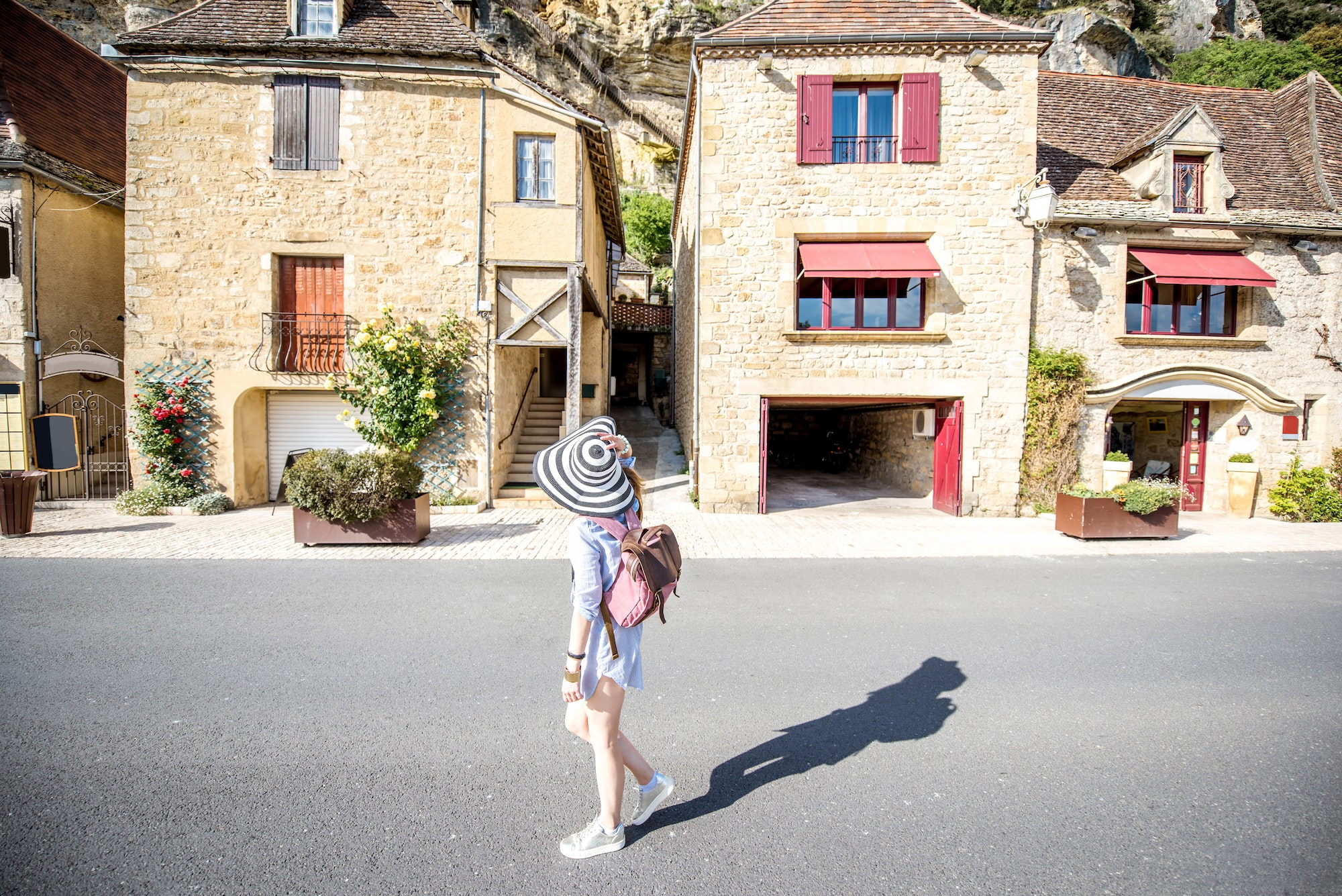 Woman traveling in La Roque Gageac village, France