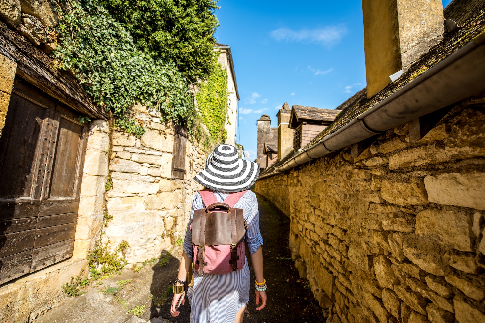 Woman traveling in La Roque Gageac village, France